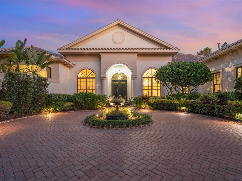 An aerial view shows a large house with a tiled roof surrounded by dense trees — 8309 FARINGTON COURT, BRADENTON, FL