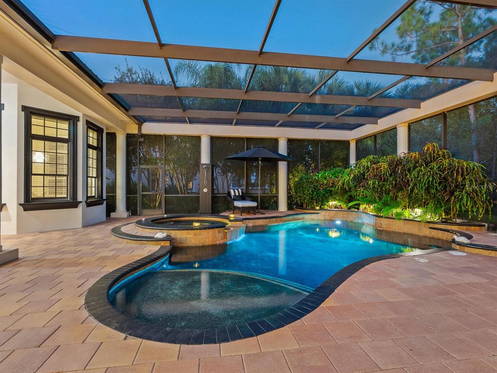 An aerial view of a large house with a tiled roof and pool in Florida — 8309 FARINGTON COURT, BRADENTON, FL