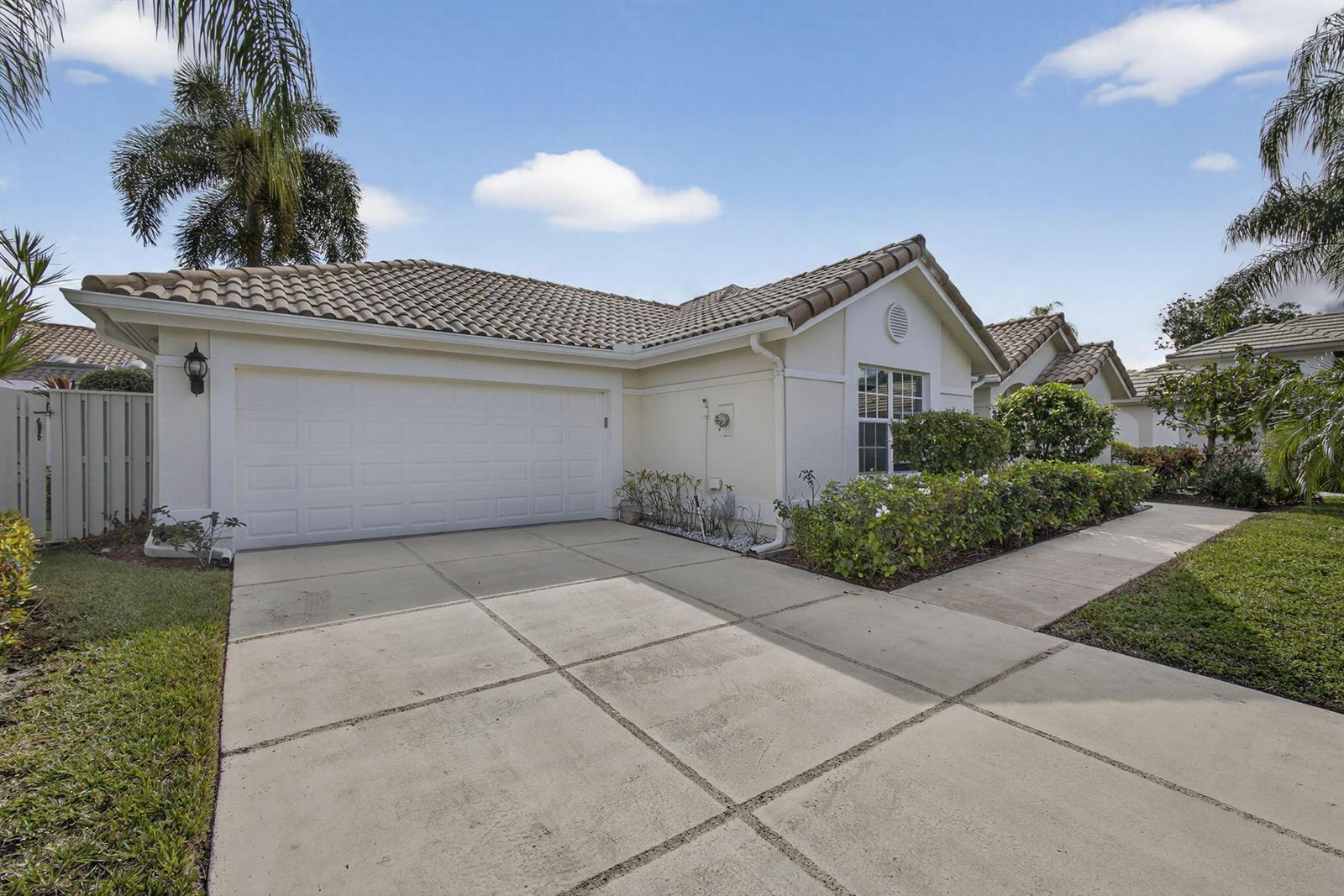 A single-story house with a white garage door, tile roof, and a concrete driveway — 152 Eagleton Court, Palm Beach Gardens FL 33418, PALM BEACH GARDENS, FL