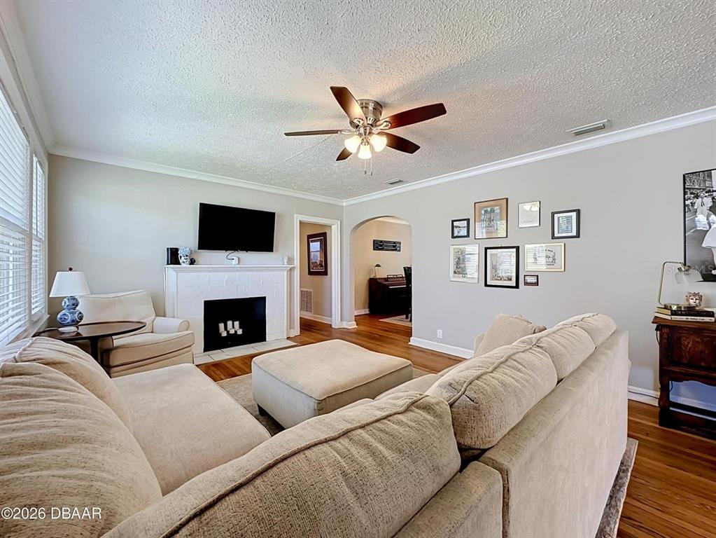 A living room features a fireplace, a sectional sofa, and a gallery wall — 2615 RIDGEWOOD ROAD, JACKSONVILLE, FL