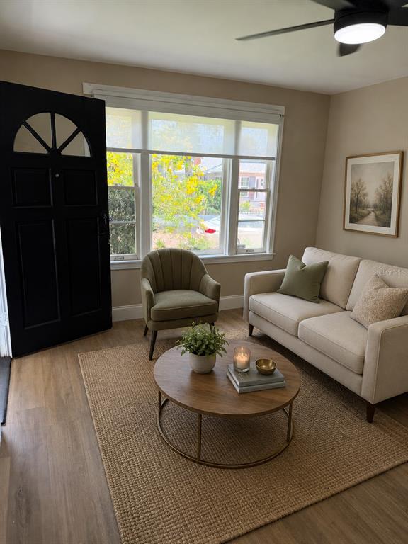 A living room features a beige sofa, green accent chair, round coffee table, and front door — 124 20TH AVENUE N, ST PETERSBURG, FL