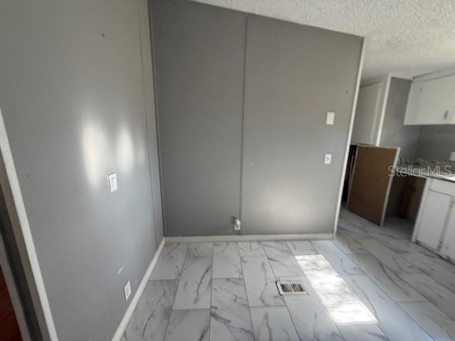 A room with gray walls, white marble-patterned tile flooring, and a floor air vent — 3903 MORGAN HORSE WAY, LAKE WALES, FL