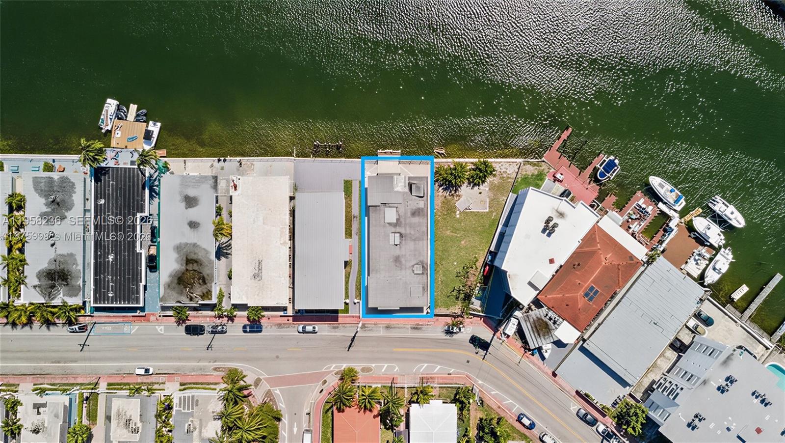 An aerial view shows a rectangular building with a flat roof situated along a waterfront — 8135 Crespi Blvd, Miami Beach FL 33141, MIAMI BEACH, FL