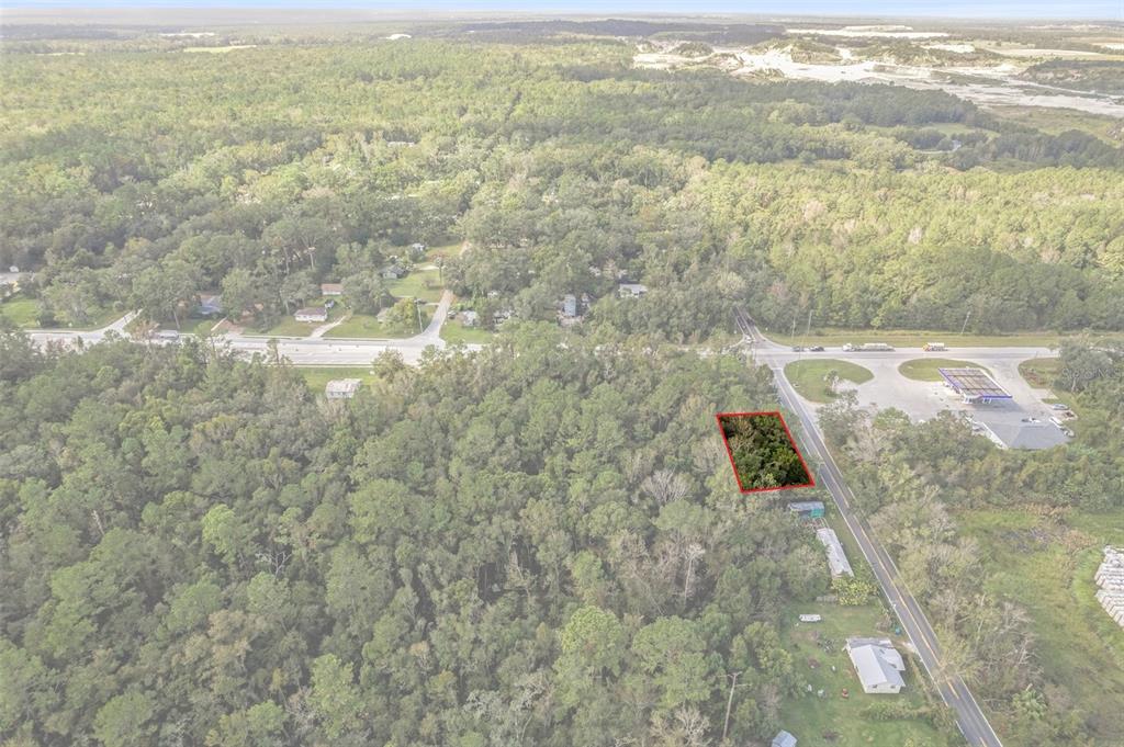 An aerial view shows a rectangular plot of land outlined in red near a road — 00 FORT DADE AVENUE, BROOKSVILLE, FL
