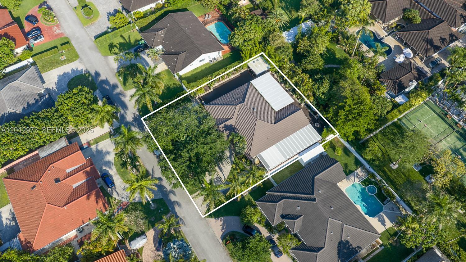 An aerial view shows a residential house with a dark roof and a pool — 10570 SW 56th Ter, Miami FL 33173, MIAMI, FL