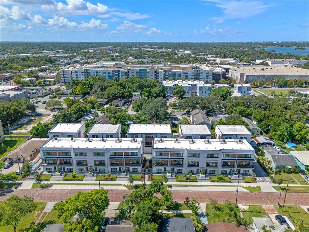 An aerial view shows a modern multi-unit residential building with flat roofs and balconies — 42 W HARDING STREET UNIT C, ORLANDO, FL