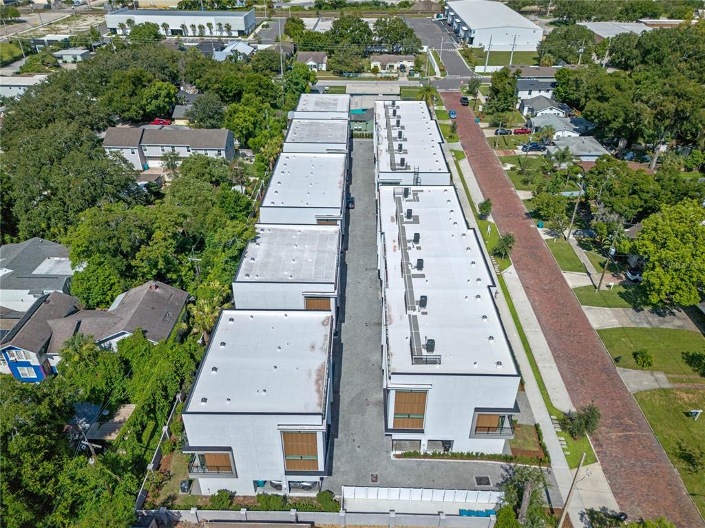An aerial view shows two rows of modern townhomes separated by a central driveway — 42 W HARDING STREET UNIT C, ORLANDO, FL