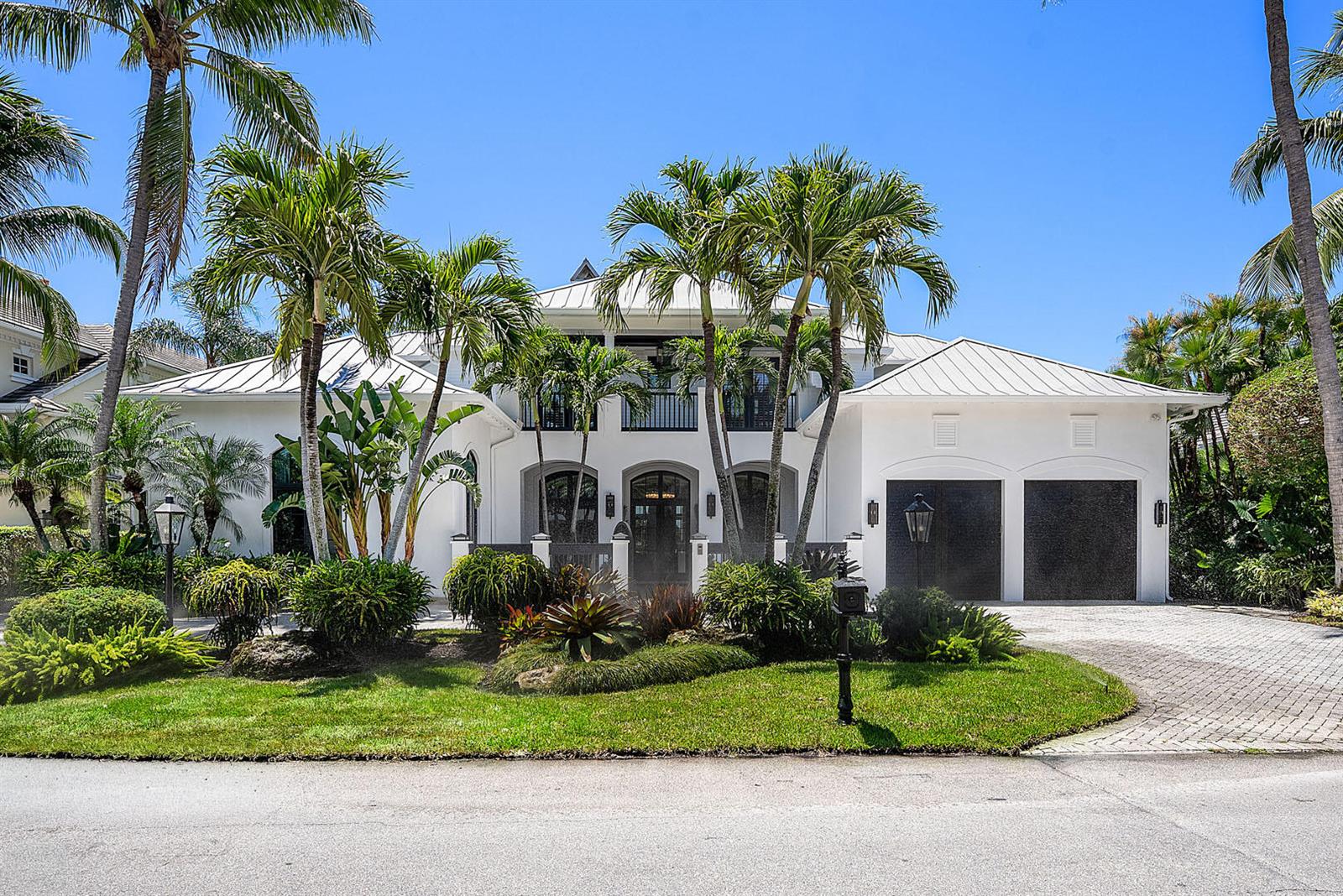 A two-story white house with a metal roof, palm trees, and a paved driveway — 1720 Sabal Palm Drive, Boca Raton FL 33432, BOCA RATON, FL