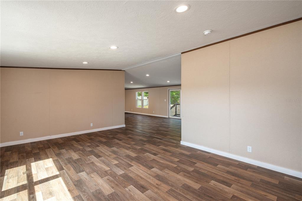 An interior view of a room with wood-look flooring, beige walls, and recessed lighting — 270 OLD BARTOW LAKE WALES, BARTOW, FL