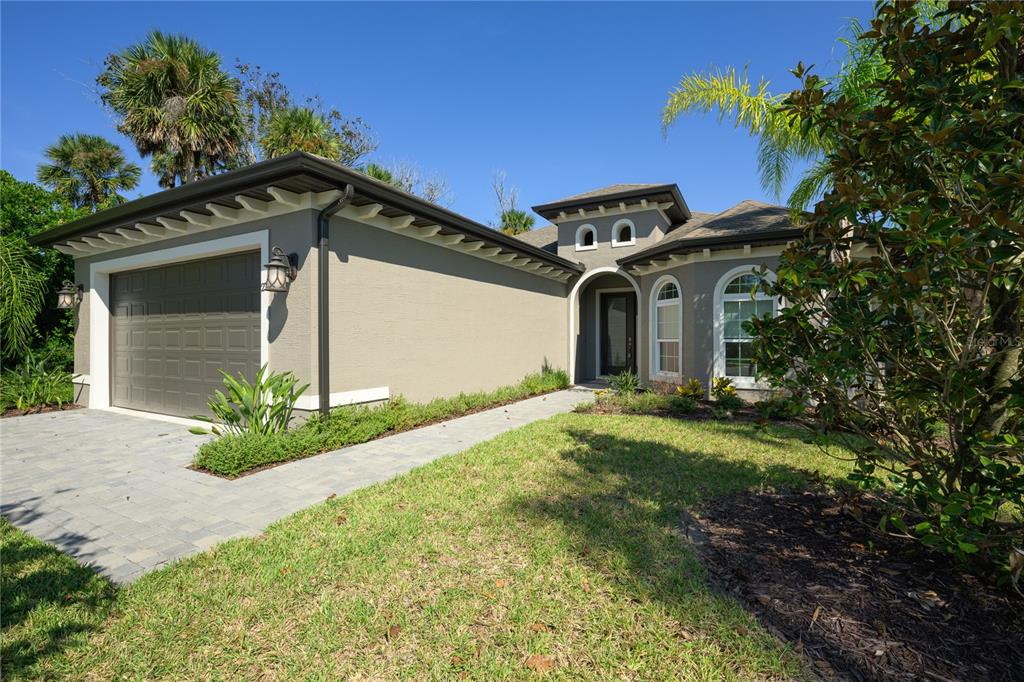 A hallway with arched ceilings, tile flooring, a bench, and framed wall art — 27 S RIVERWALK DRIVE, PALM COAST, FL
