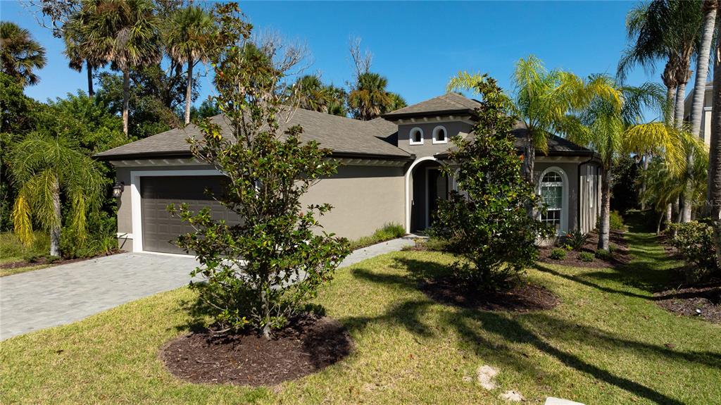 An entryway features light gray walls, tile flooring, and a white door with glass panels — 27 S RIVERWALK DRIVE, PALM COAST, FL