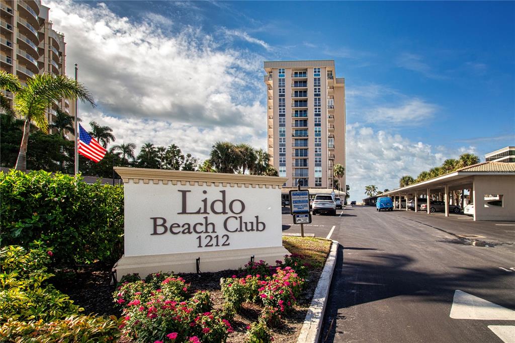 A sign for the Lido Beach Club stands in front of a multi-story residential building — 1212 BENJAMIN FRANKLIN DRIVE UNIT 607, SARASOTA, FL