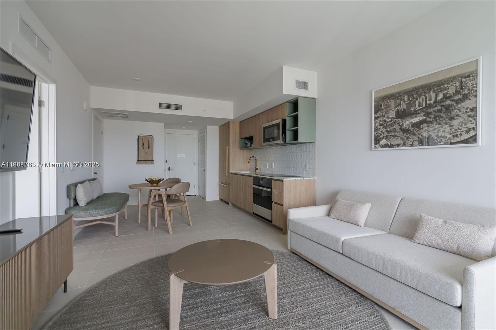 This studio apartment features a kitchenette, a dining area, and a living space — 159 NE 6th St # 3404, Miami FL 33132, MIAMI, FL