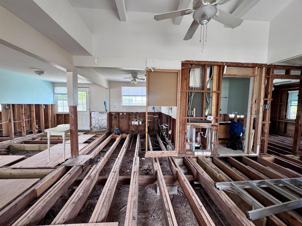 An interior view of a room under construction with exposed floor joists and wall studs — 202 12TH AVENUE, INDIAN ROCKS BEACH, FL