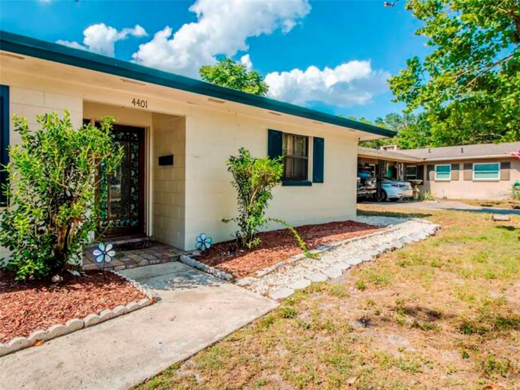 A single-story house with a cream-colored exterior, dark trim, and a front walkway — 4401 LENMORE STREET UNIT 2, ORLANDO, FL