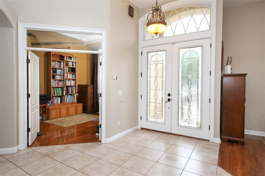 An entryway with tile flooring, a double front door with glass inserts, and an adjacent office — 5695 POND PINE POINT, OVIEDO, FL