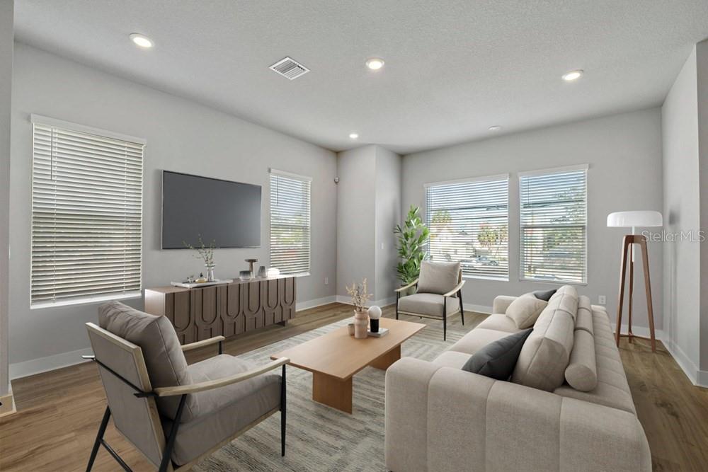 A modern living room features a sofa, two armchairs, a wooden coffee table, and a television — 89 28TH STREET S, ST PETERSBURG, FL