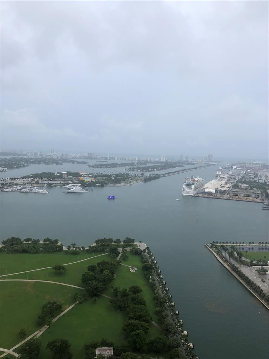 An aerial view shows a park, a waterway with cruise ships, and a distant city skyline — 900 Biscayne Blvd # 4904, Miami FL 33132, MIAMI, FL