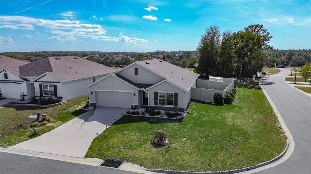 An aerial view shows a light-colored single-story house with a two-car garage and fenced yard — 662 W FAIRWAYS VIEW DRIVE, BEVERLY HILLS, FL