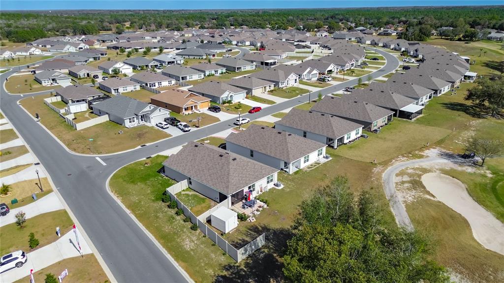 An aerial view shows a suburban neighborhood with single-family homes, paved streets, and a golf course — 662 W FAIRWAYS VIEW DRIVE, BEVERLY HILLS, FL