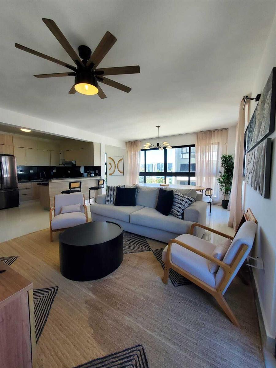 A living room with a sofa, two armchairs, a coffee table, and an open kitchen — 50 C. Los Fereira # I8, FL