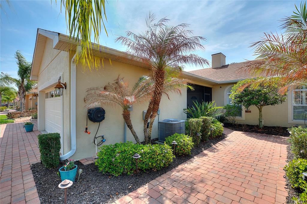A paved walkway leads to the front entrance of a house with a garage and landscaping — 1678 LINZ COURT, WINTER HAVEN, FL