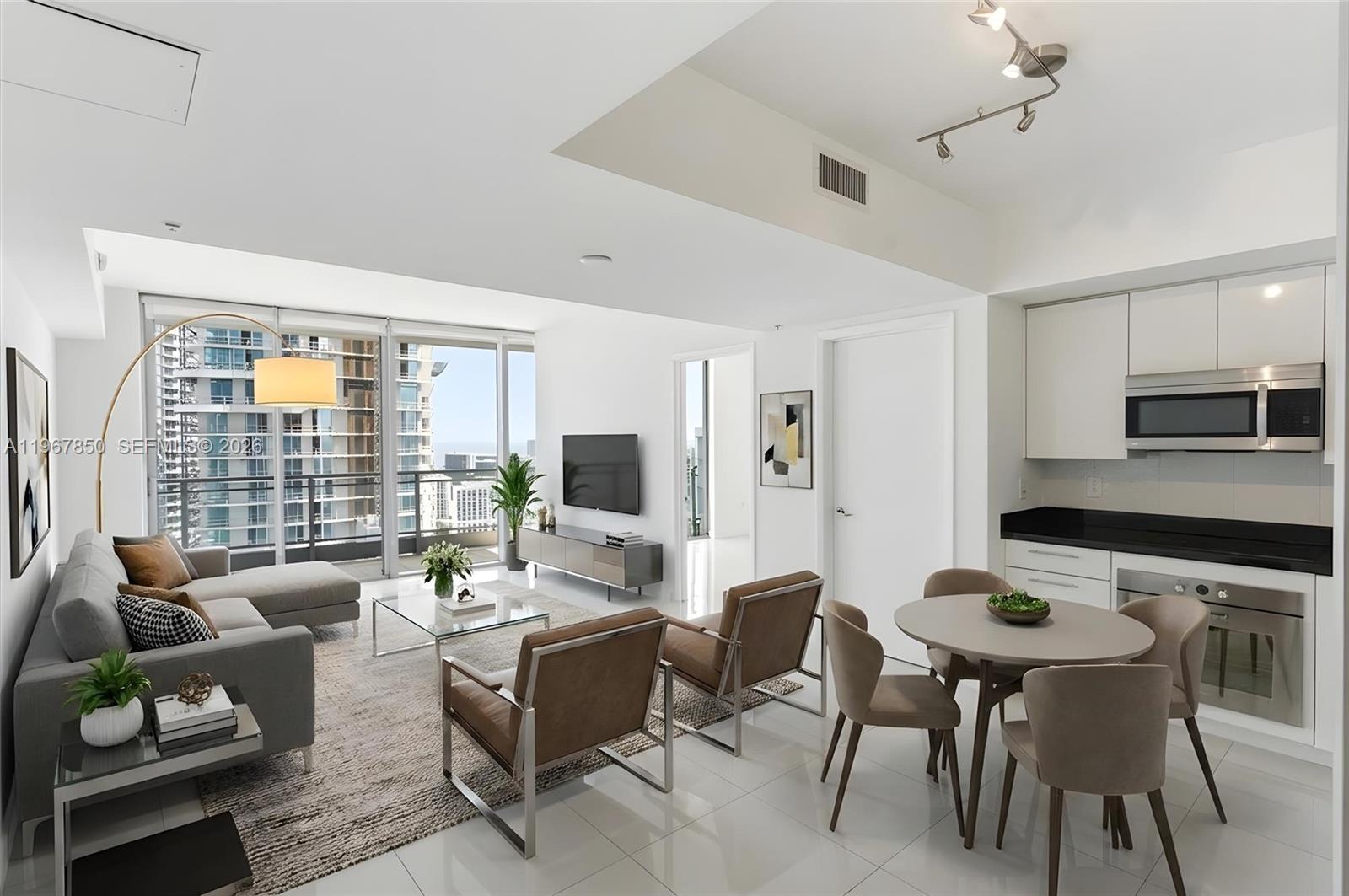 A modern open-concept living and dining area with white walls, tile floors, and city views — 92 SW 3rd St # 3804, Miami FL 33130, MIAMI, FL
