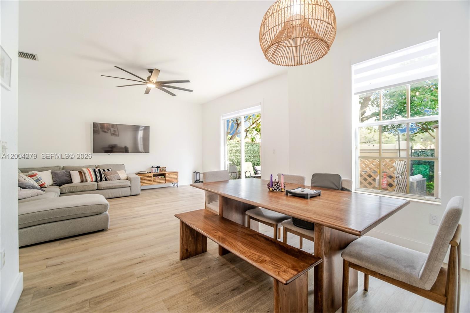 A bright open-concept living and dining area features light wood flooring and modern furniture — 4414 Morgan Ln, Davie FL 33328, DAVIE, FL