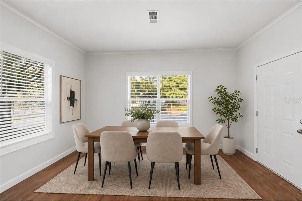 A dining room features a wooden table, six chairs, a rug, and two windows — 5430 ROSE AVENUE, ORLANDO, FL