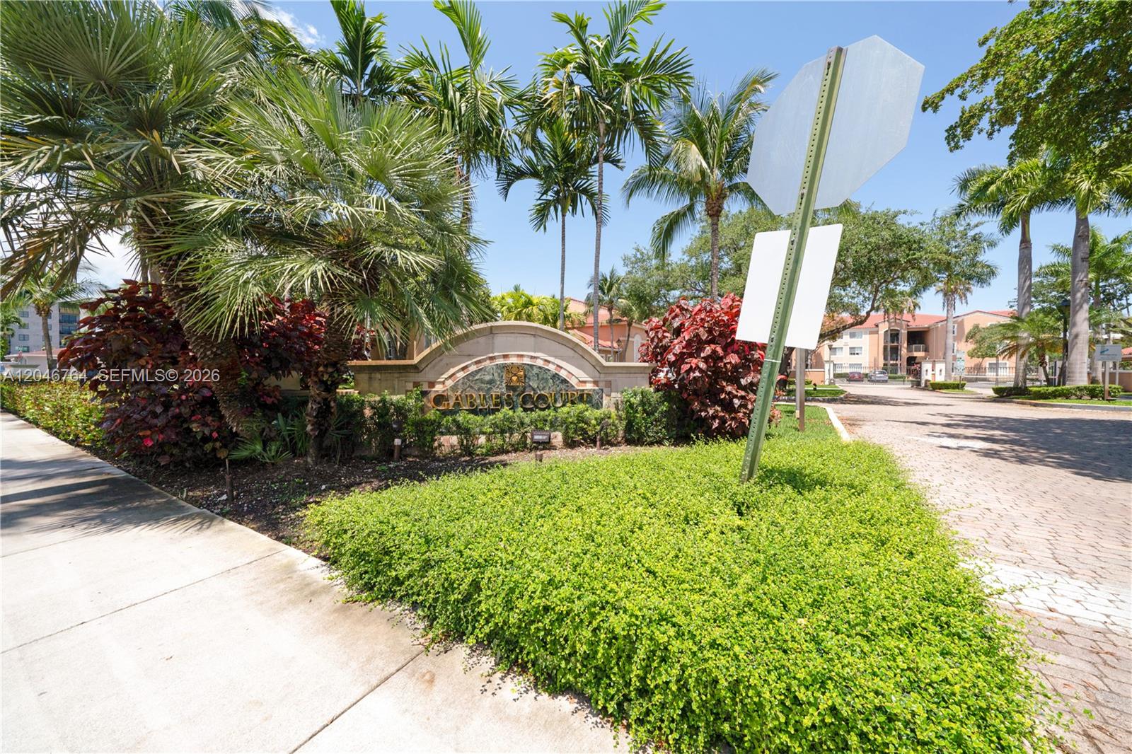 The entrance sign for Gables Court is surrounded by palm trees and lush landscaping — 6851 SW 44th St # 208, Miami FL 33155, MIAMI, FL