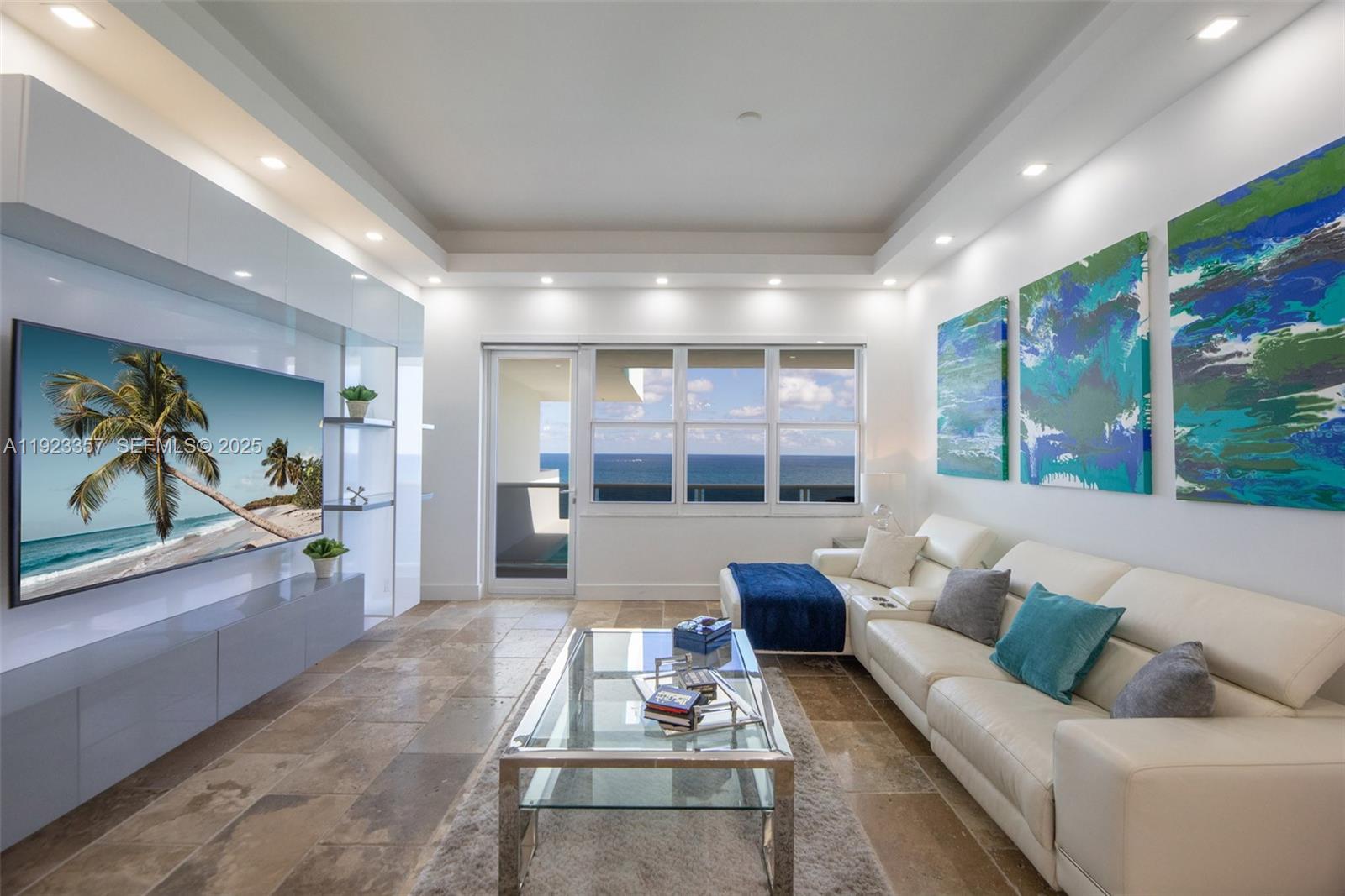 A living room features a white sectional sofa, glass coffee table, and ocean view windows — 3725 S Ocean Dr, Hollywood FL 33019, HOLLYWOOD, FL