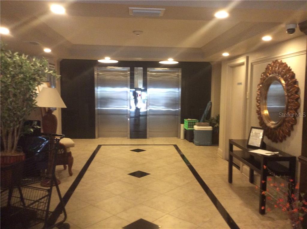 An elevator lobby features tiled floors, a decorative mirror, and a console table — 33 S GULFSTREAM AVENUE UNIT 1001, SARASOTA, FL