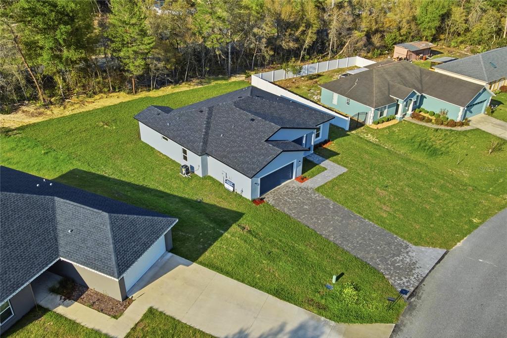 An aerial view shows a modern single-story house with a paved driveway and large lawn — 13695 SW 40TH CIRCLE, OCALA, FL