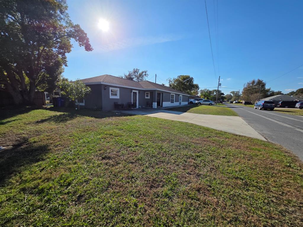 A single-story gray house with a concrete driveway sits on a grassy lot — 600 GEORGIA AVENUE, ST CLOUD, FL