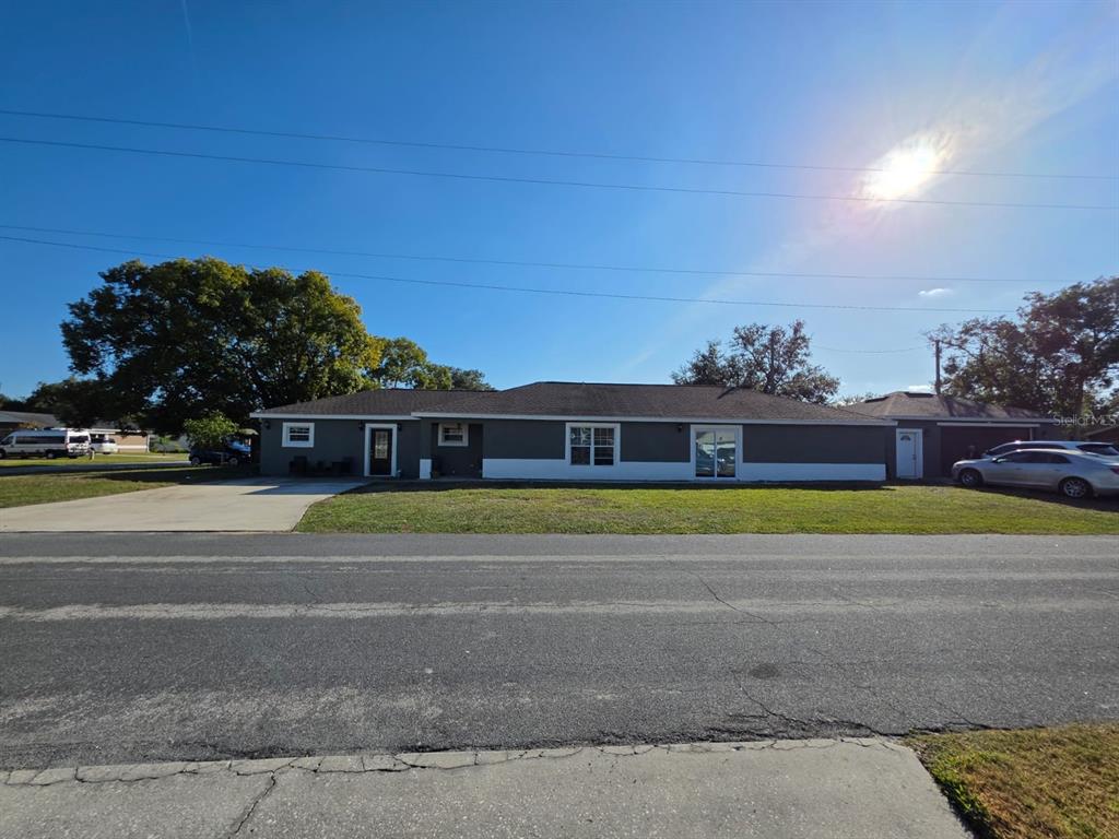 A single-story house with a gray exterior, white trim, and a concrete driveway — 600 GEORGIA AVENUE, ST CLOUD, FL