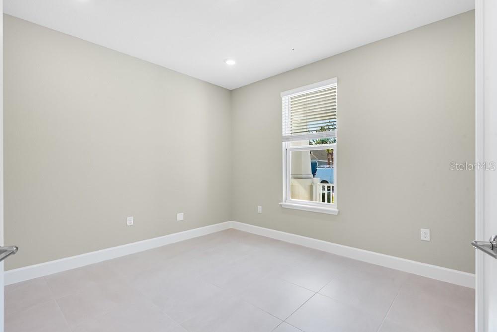 An empty room with light gray walls, tile flooring, and a single window — 10 GEOSAM DRIVE, PALM COAST, FL