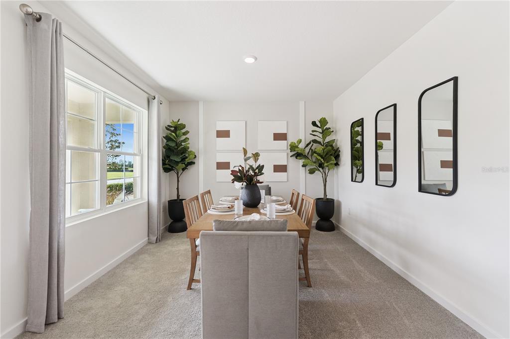 A dining room with a wooden table, six chairs, two potted plants, and wall mirrors — 1132 HUDSON HARBOR LANE, KISSIMMEE, FL
