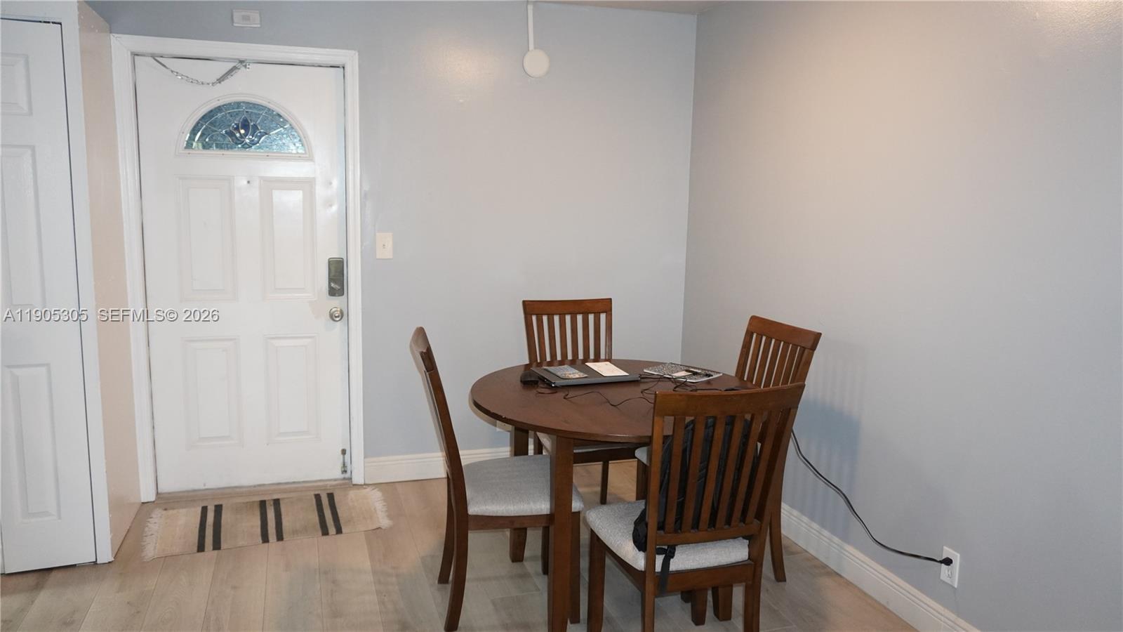 A dining area features a round wooden table with four chairs on light flooring — 3710 N Pine Island Rd # 320, Sunrise FL 33351, SUNRISE, FL