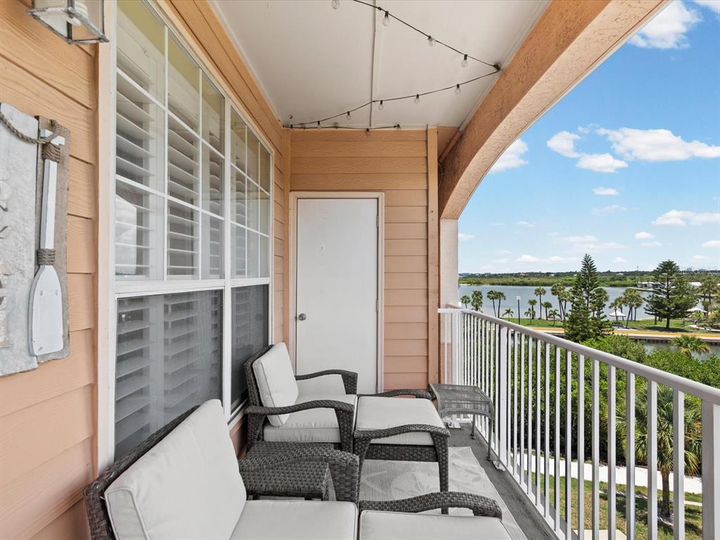 A bathroom features a dark wood vanity, granite countertop, and a tiled walk-in shower — 5000 CULBREATH KEY WAY UNIT 9-301, TAMPA, FL