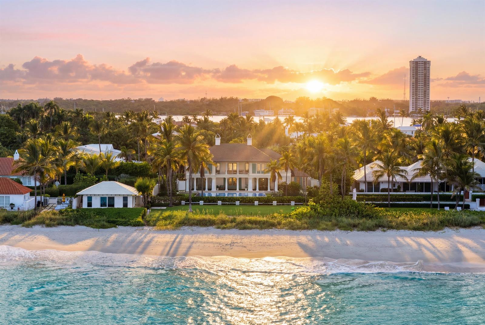 An aerial view of a beachfront estate with palm trees at sunset — 1285 N Ocean Boulevard, Palm Beach FL 33480, PALM BEACH, FL