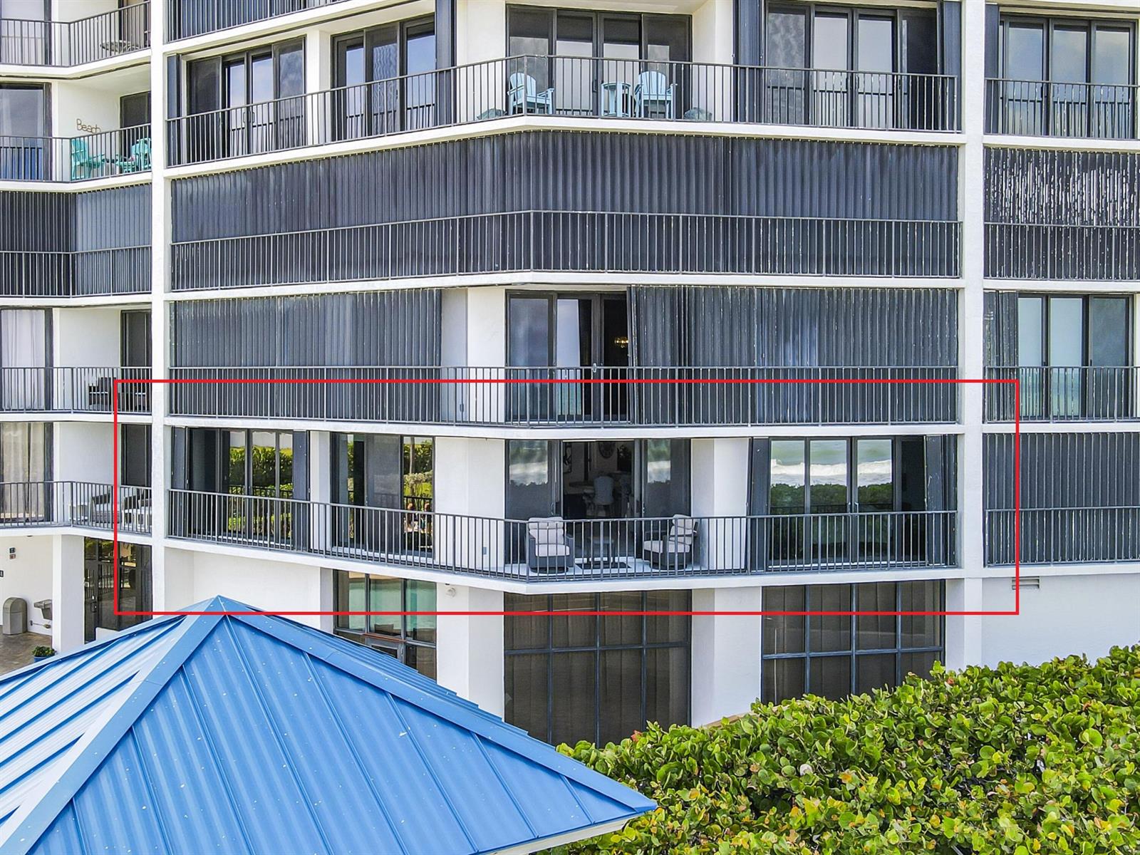An exterior view of a multi-story building featuring balconies with metal railings and sliding doors — 9650 S Ocean Drive # 106, Jensen Beach FL 34957, JENSEN BEACH, FL