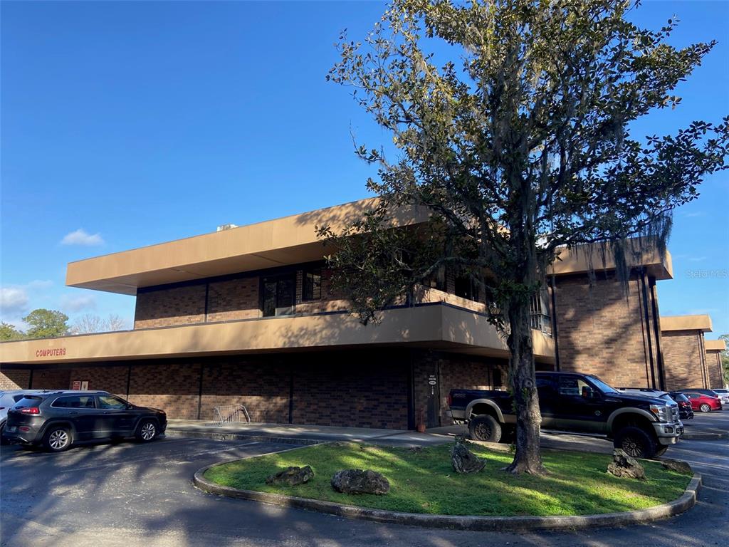 A two-story brick commercial building with a flat roof and a parking lot — 3501 SW 2ND AVENUE UNIT 2300, GAINESVILLE, FL