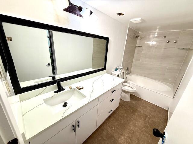 A modern bathroom features a white vanity with a marble countertop, black fixtures, and a tub — 2202 S Cypress Bend Drive # 101, Pompano Beach FL 33069, POMPANO BEACH, FL
