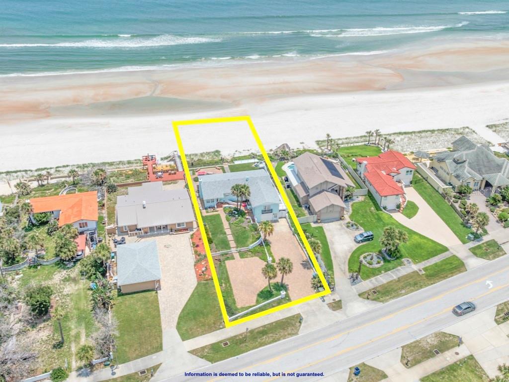 An aerial view shows a beachfront house with a large yard and private beach access — 3873 S ATLANTIC AVENUE, DAYTONA BEACH SHORES, FL