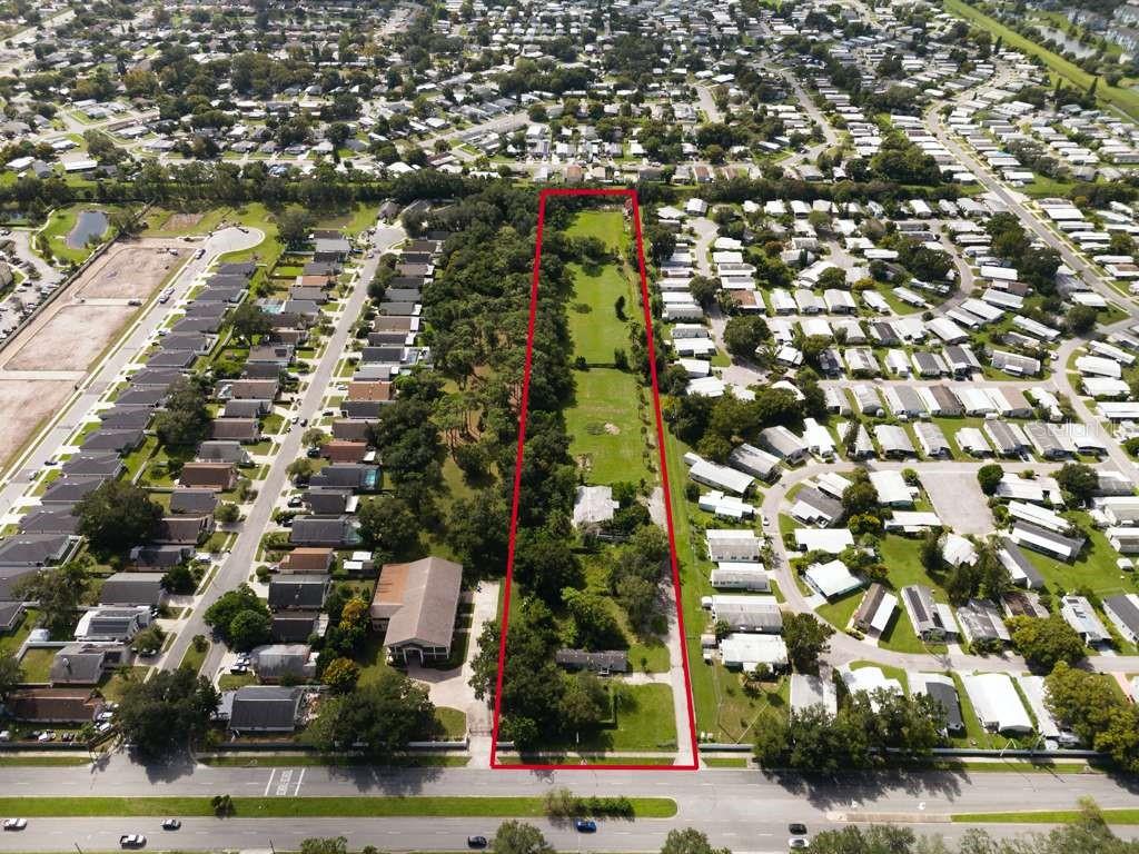 An aerial view shows a long, rectangular residential lot outlined in red between two neighborhoods — 6250 PERSHING AVENUE, ORLANDO, FL