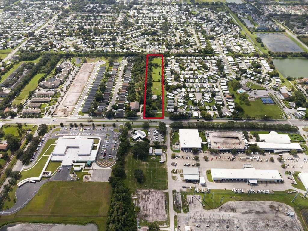 An aerial view shows a rectangular plot of land outlined in red near residential neighborhoods — 6250 PERSHING AVENUE, ORLANDO, FL