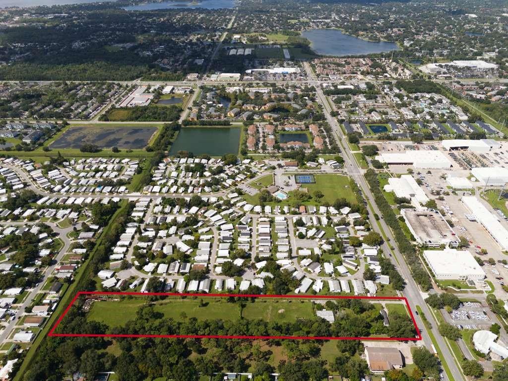 An aerial view shows a rectangular plot of land outlined in red near a neighborhood — 6250 PERSHING AVENUE, ORLANDO, FL