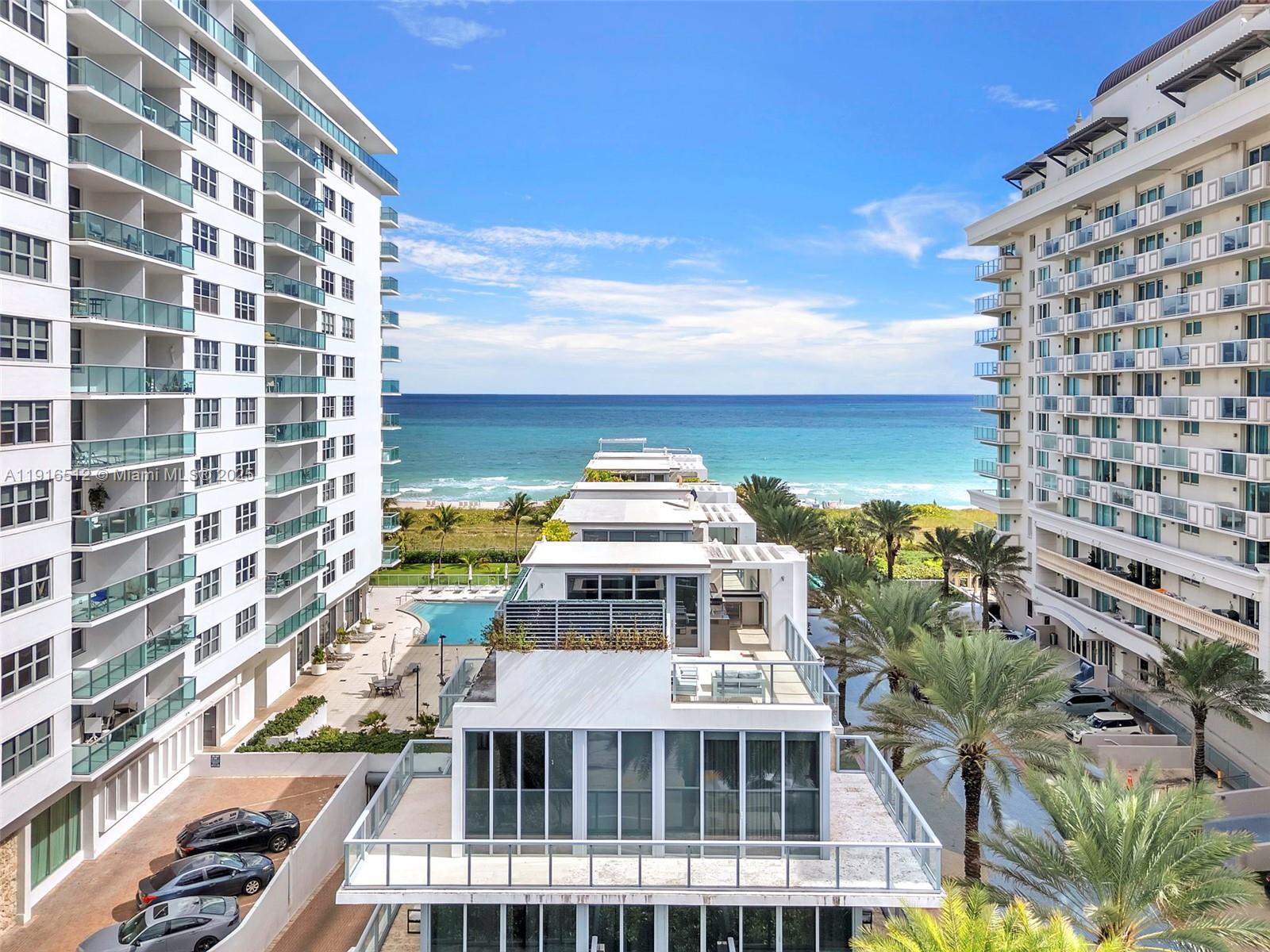 An elevated view shows a modern residential complex with a pool between two tall buildings — 9501 Collins Ave # 1, Surfside FL 33154, SURFSIDE, FL