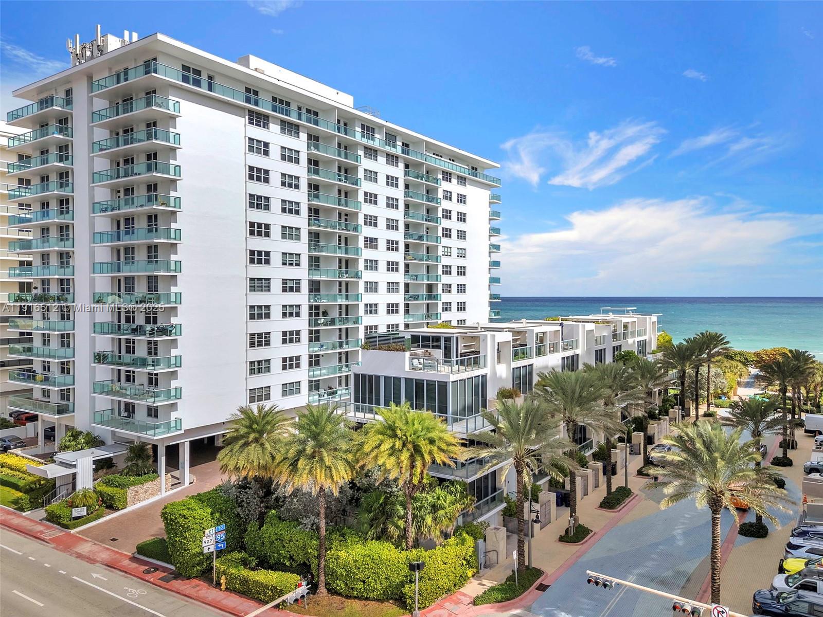 An exterior view of a multi-story white apartment building with balconies and palm trees — 9501 Collins Ave # 1, Surfside FL 33154, SURFSIDE, FL