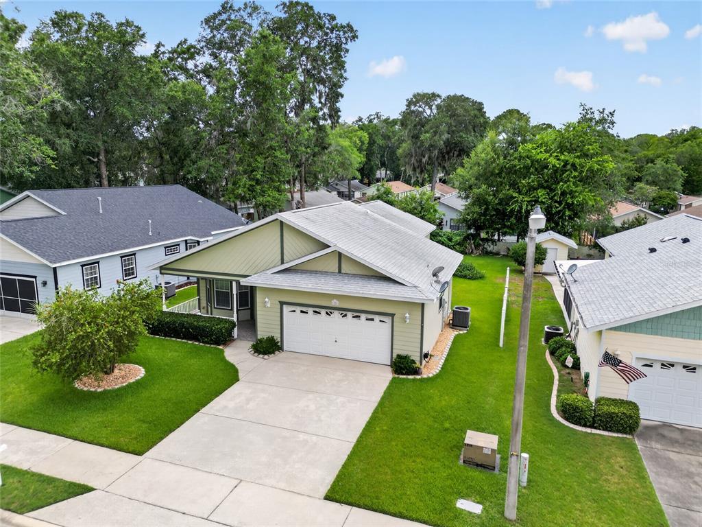 An aerial view of a light green suburban house with a two-car garage and lawn — 2216 NE 40TH TERRACE, OCALA, FL